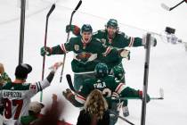 Minnesota Wild left wing Kevin Fiala (22) is congratulated by Joel Eriksson Ek (14) and Mats Zu ...