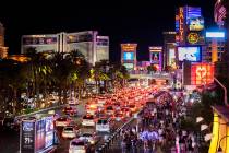 FILE - In this March 19, 2021, file photo, vehicles and crowds move along the strip in Las Vega ...