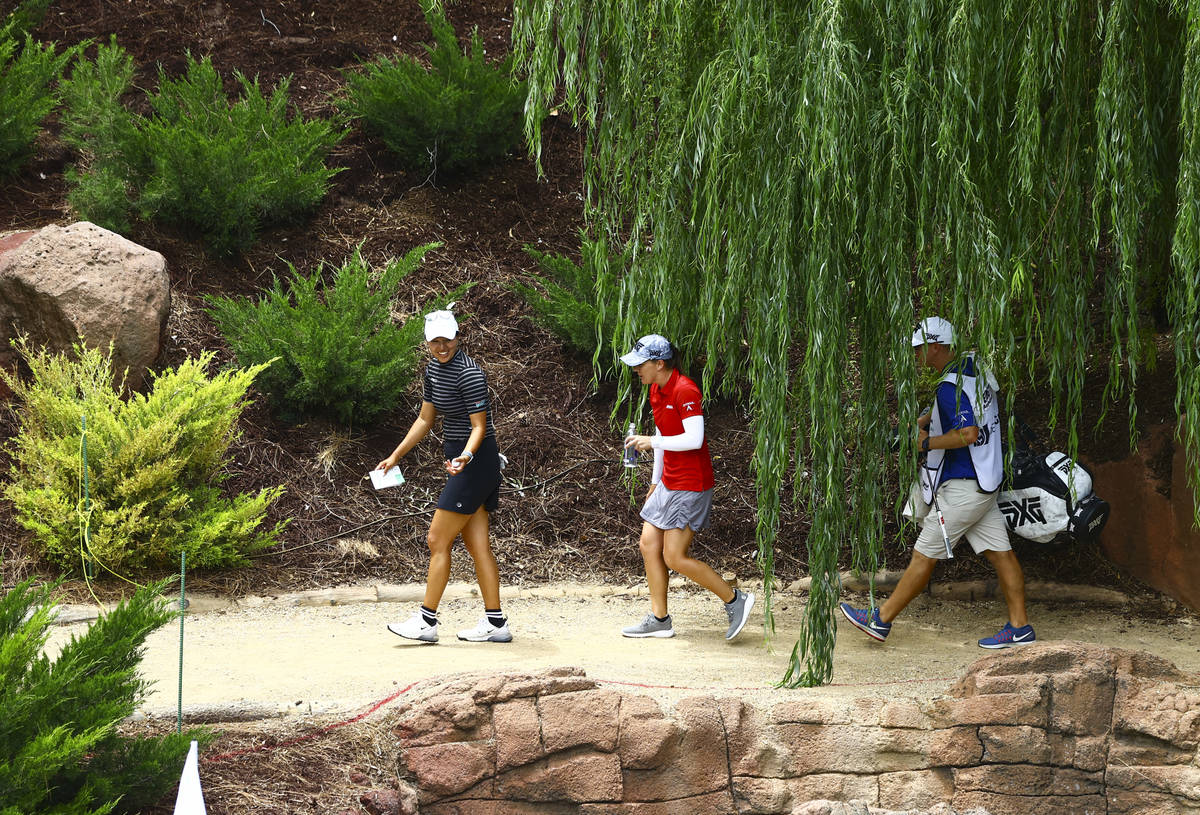 Annie Park, left, and Austin Ernst head to the 18th hole during the first round of the Bank of ...