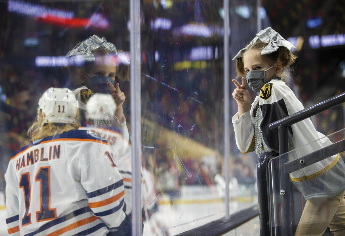 Henderson Silver Knights fan Emmalynne Patterson, right, lets Bakersfield Condors players know ...