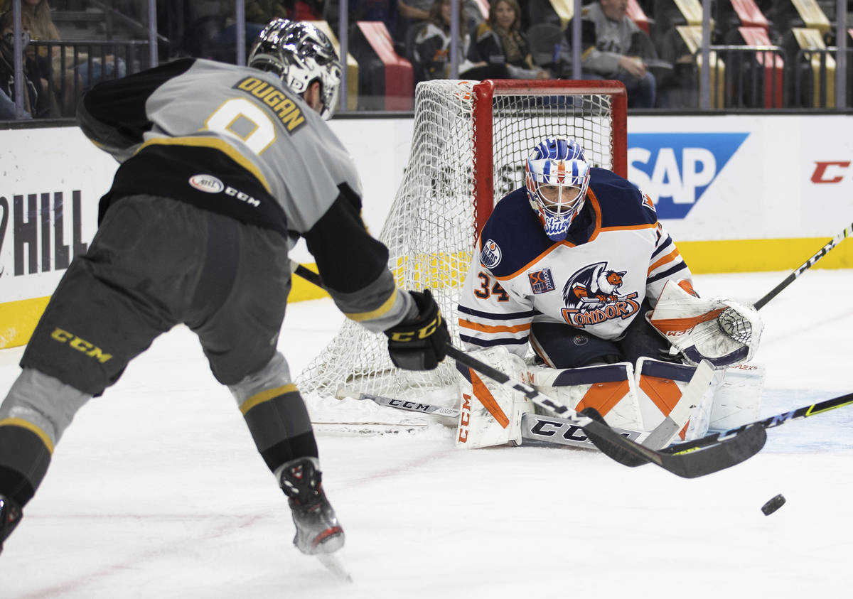 Henderson Silver Knights forward Jack Dugan (8) shoots on Bakersfield Condors goaltender Stuart ...