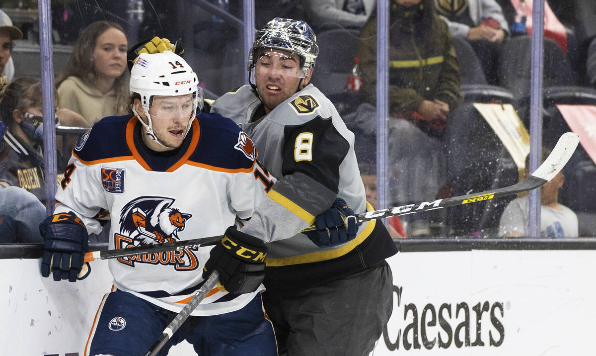 Henderson Silver Knights forward Jack Dugan (8) collides with Bakersfield Condors left wing Dev ...