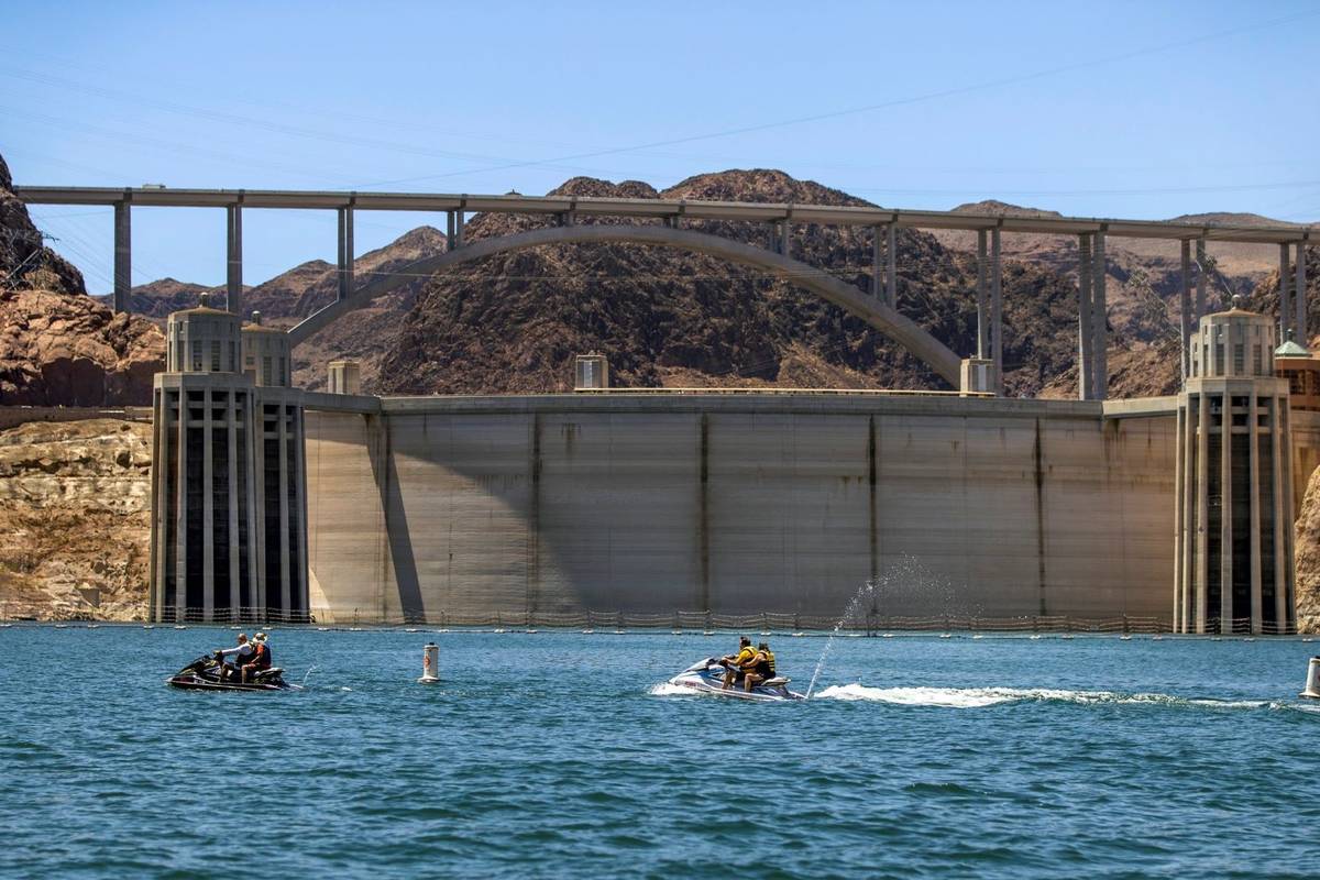 Jet skiers check out the high side of Hoover Dam while tooling around on the water within the L ...