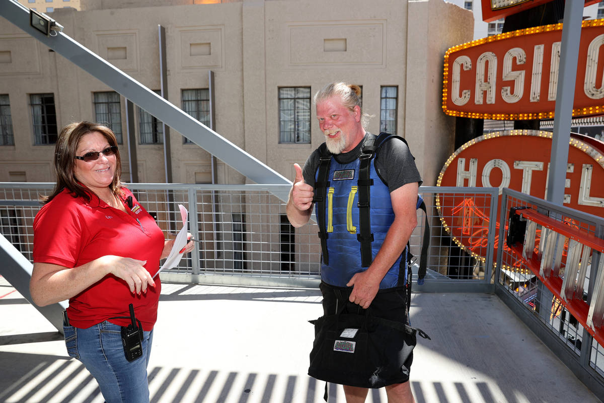 Tony Cox of Las Vegas is offered a job by Lynn Commisso after riding the zip line during a Slot ...