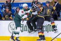 Golden Knights right wing Ryan Reaves (75) and Minnesota Wild left wing Jordan Greenway (18) ta ...