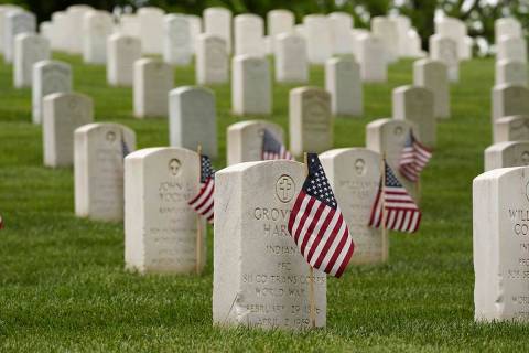 American flags are displayed next to veterans' graves ahead of Memorial Day at the Crown Hill N ...