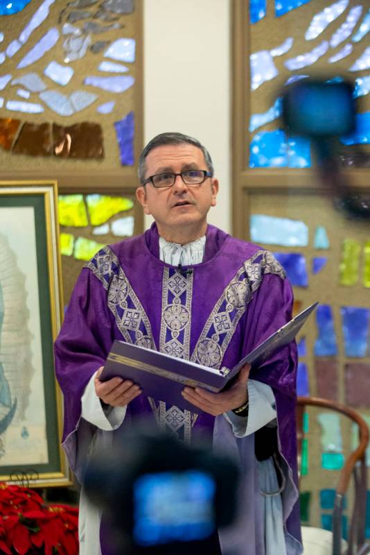 Cameras record Monsignor Gregory Gordon celebrating a virtual Mass at the the Roman Catholic Di ...