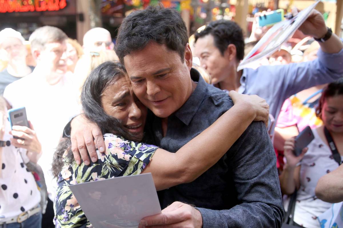 Strip headliner Donny Osmond hugs Lucie Hanna of Canoga Park, Calif., after receiving a Key to ...