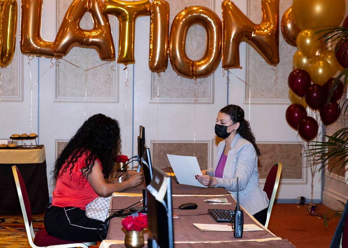 A newly hired employee discusses with Laura Hermosillo, right, a talent acquisition for the Ven ...
