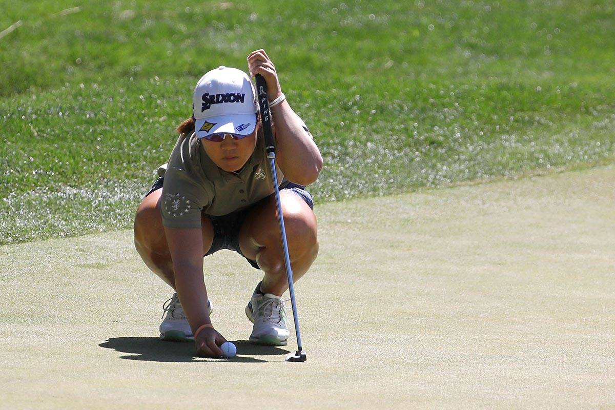 Nasa Hataoka of Japan places a ball on the first green during the third round of the Bank of Ho ...