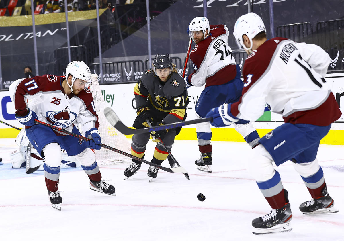 Golden Knights' William Karlsson (71) chases after the puck between Colorado Avalanche's Tyson ...