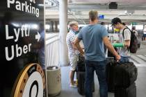 Arriving passengers wait for their ride at ride share waiting area at McCarran International Ai ...