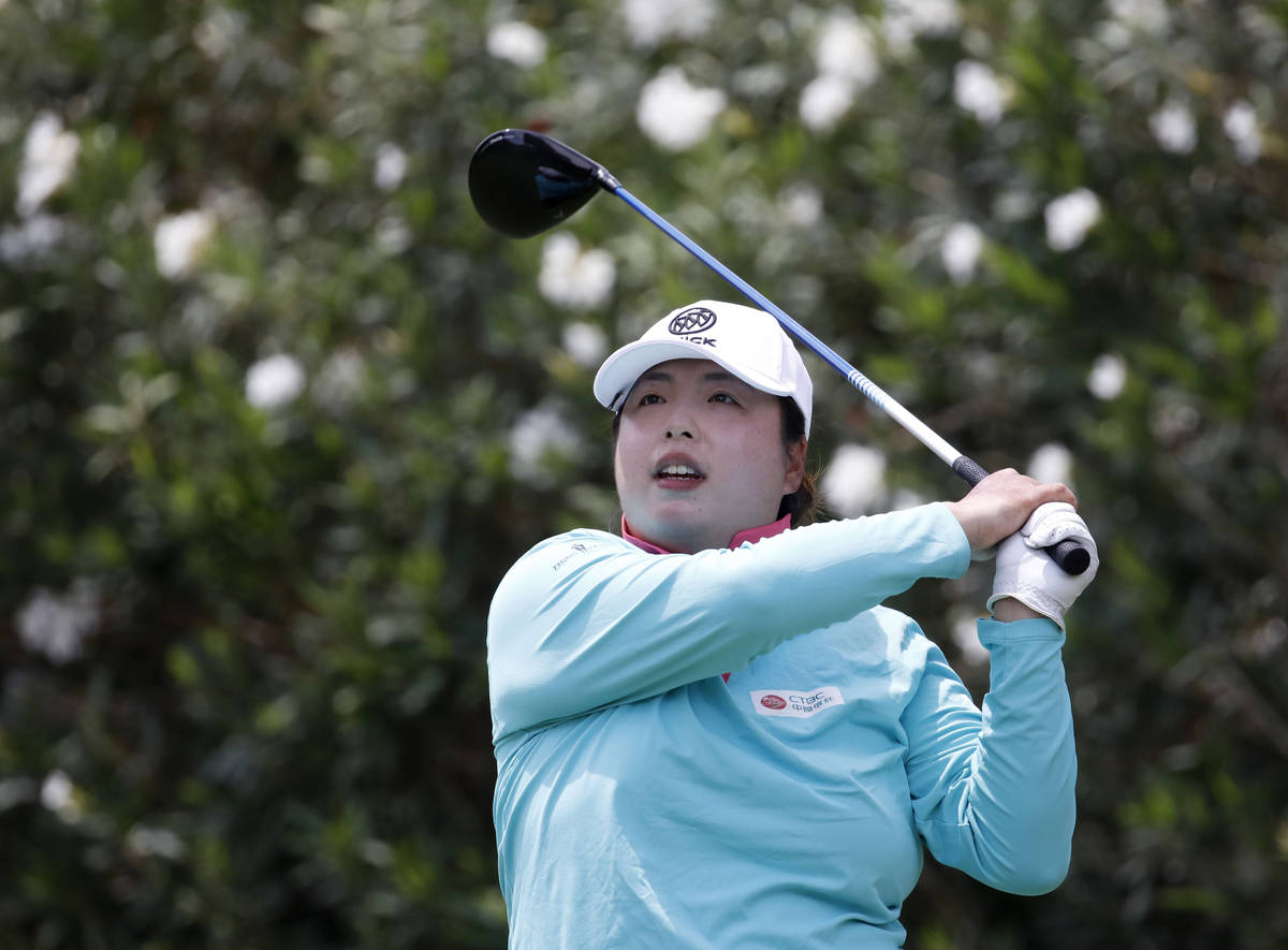 Shanshan Feng watches her tee shot on the first hole during the quarter final round of the Bank ...