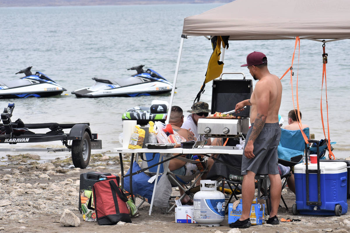 Ralph Flores of San Bernardina, CA mans the grill on Saturday, May 29, 2021 while the family en ...