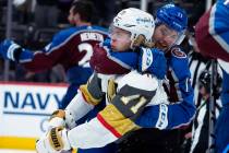 Colorado Avalanche center Tyson Jost (17) fights with Vegas Golden Knights center William Karls ...