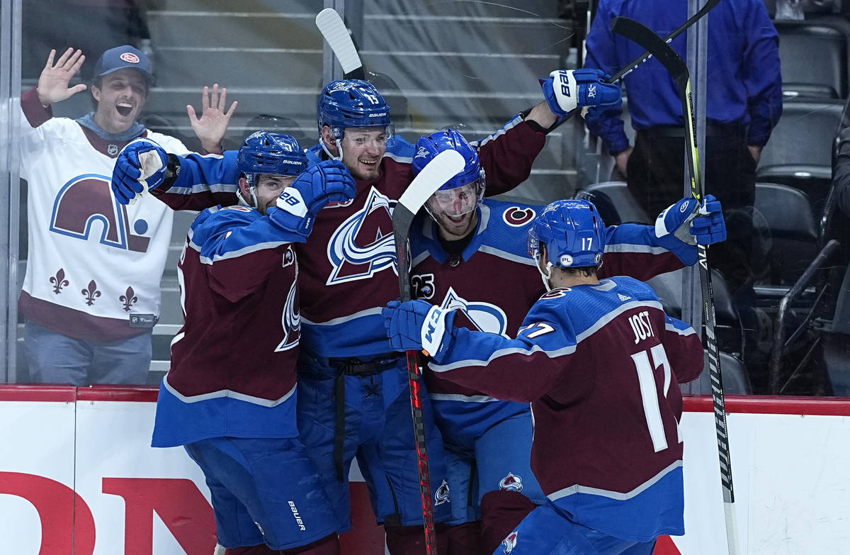 Colorado Avalanche left wing Brandon Saad (20) is congratulated by teammates Devon Toews (7), V ...