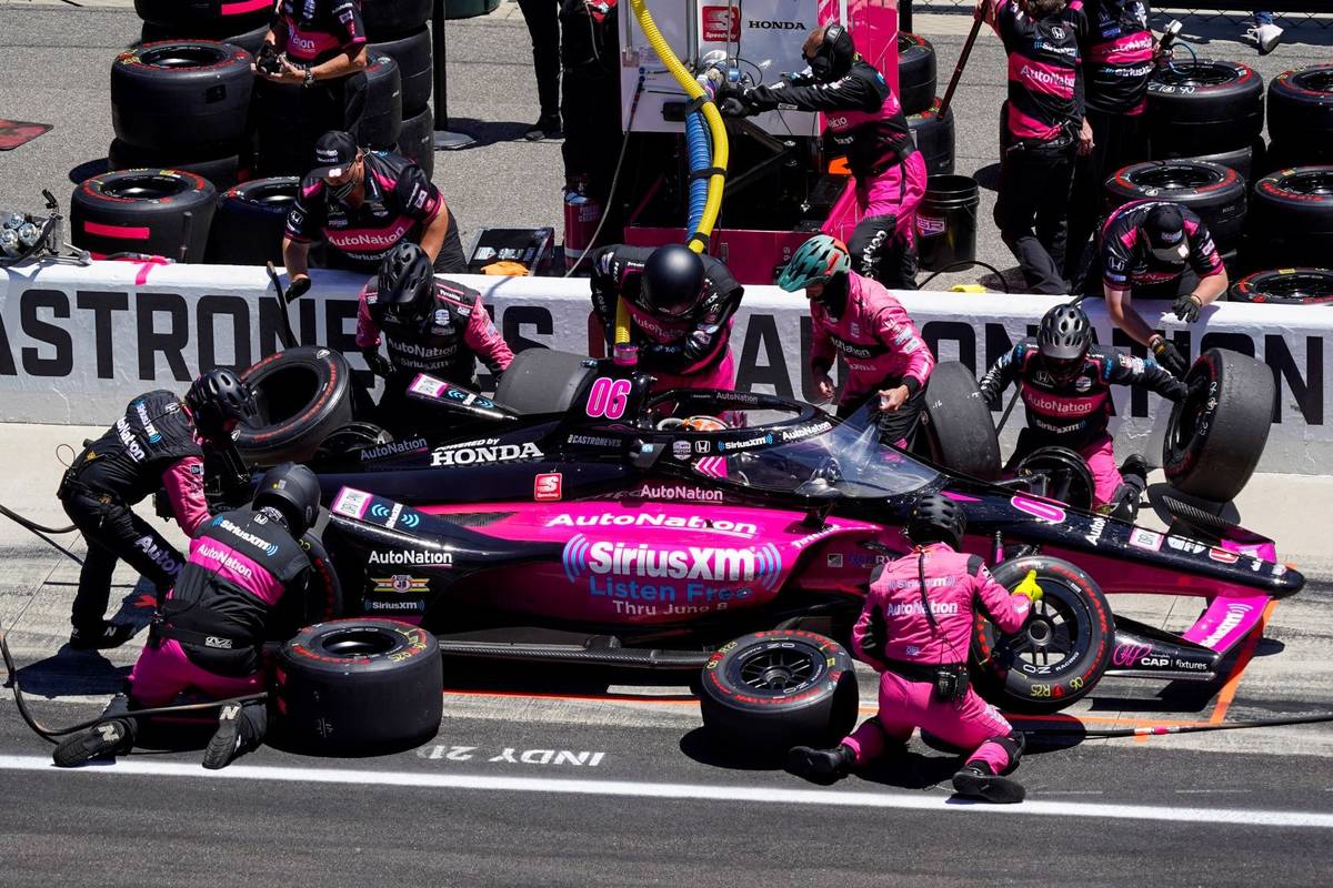 Helio Castroneves, of Brazil, pits during the Indianapolis 500 auto race at Indianapolis Motor ...