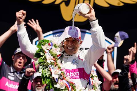 Helio Castroneves of Brazil celebrates after winning the Indianapolis 500 auto race at Indianap ...
