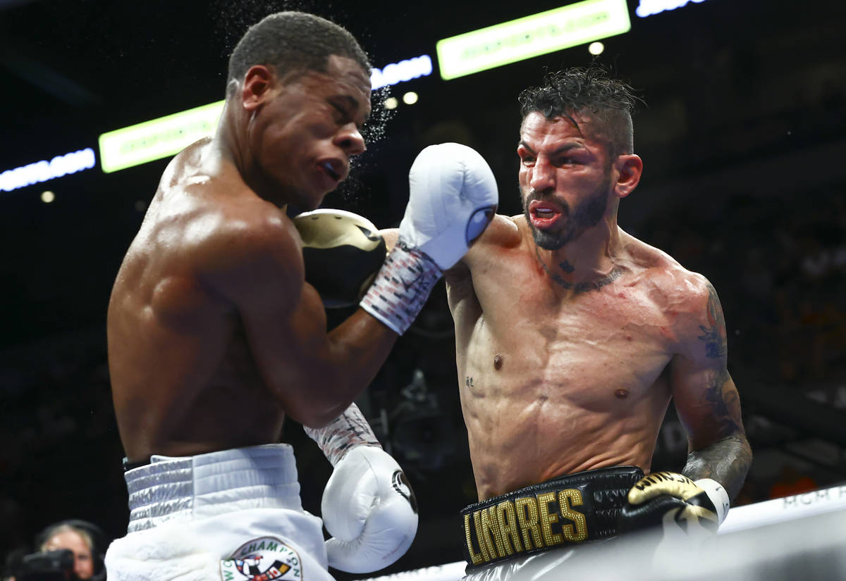 Jorge Linares, right, punches Devin Haney during the WBC lightweight title boxing match Saturda ...