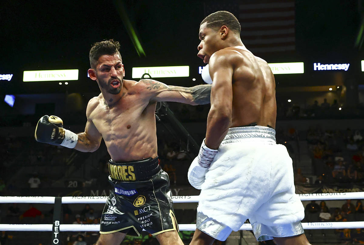 Jorge Linares, left, hits Devin Haney during a WBC lightweight title boxing match Saturday, May ...