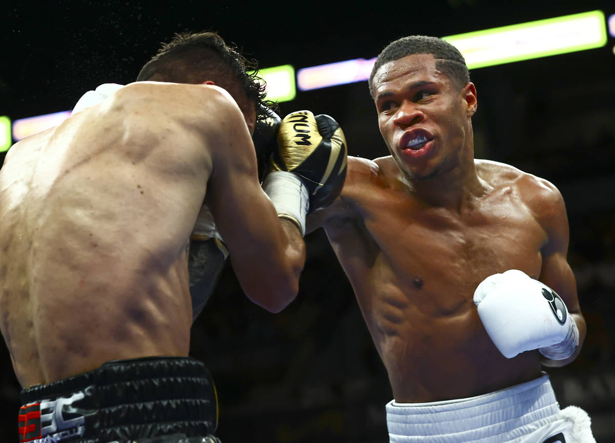 Devin Haney, right, punches Jorge Linares during the WBC lightweight title boxing match Saturda ...