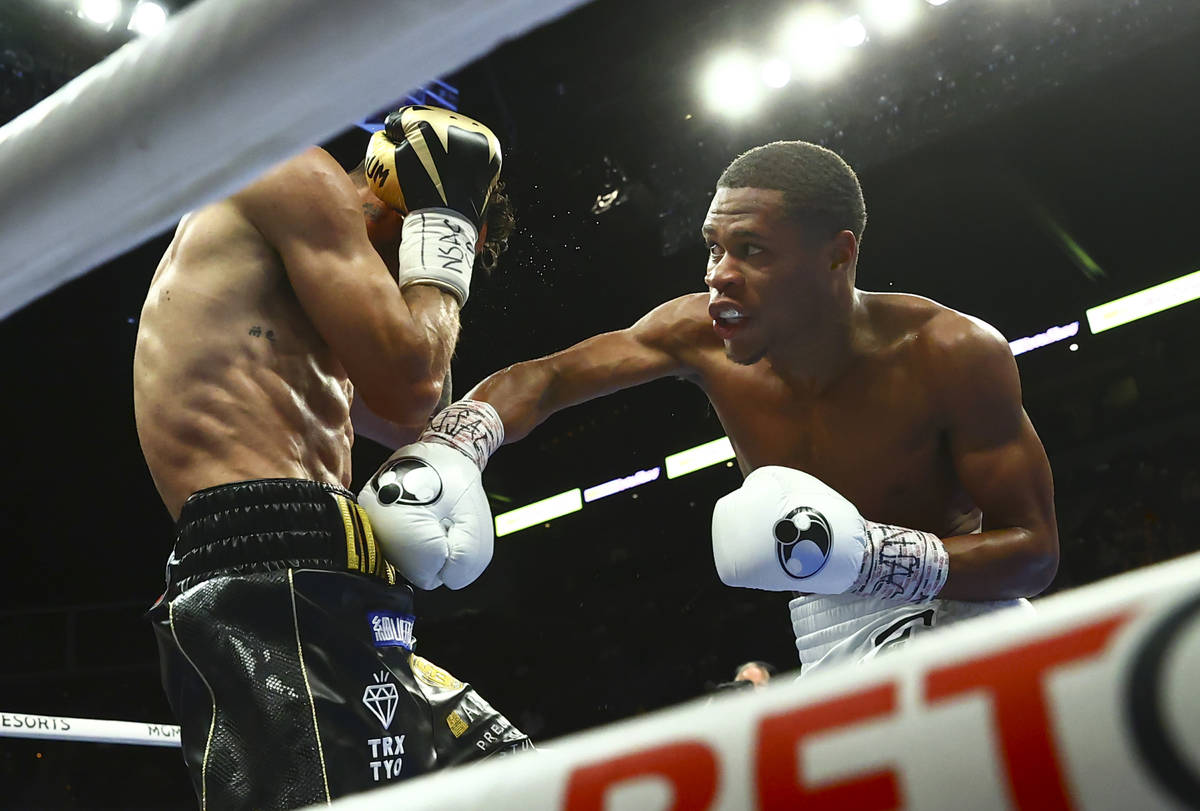 Devin Haney, right, hits Jorge Linares during the WBC lightweight title boxing match Saturday, ...