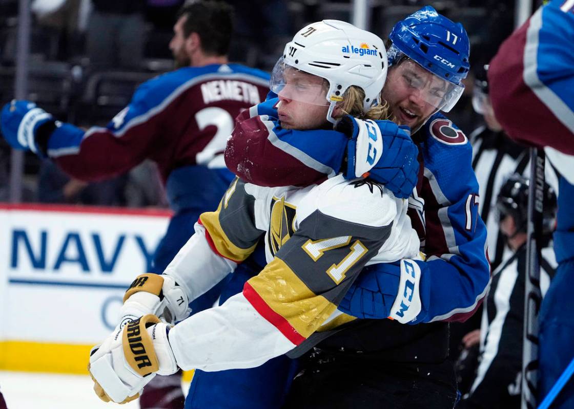 Colorado Avalanche center Tyson Jost (17) fights with Vegas Golden Knights center William Karls ...