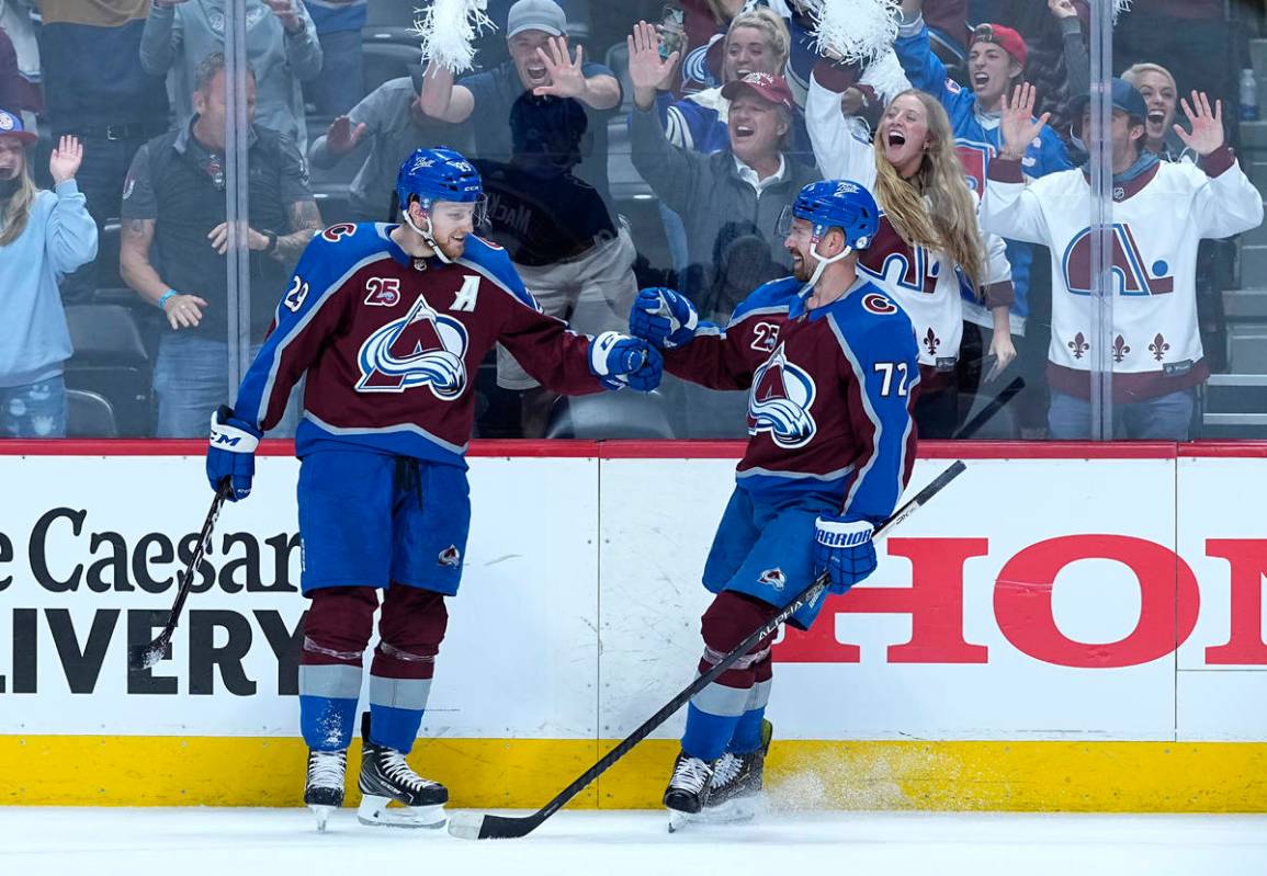 Colorado Avalanche center Nathan MacKinnon (29) is congratulated by teammate Joonas Donskoi (72 ...