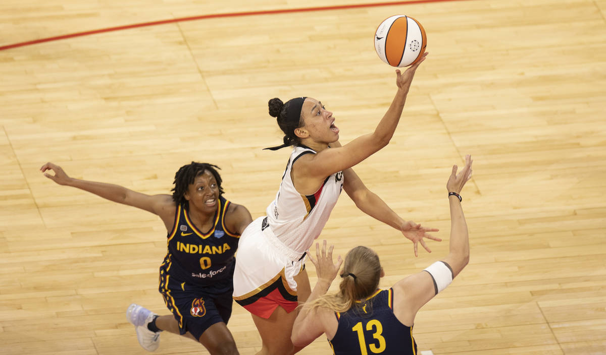 Las Vegas Aces forward Dearica Hamby (5) slices past Indiana Fever guard Kelsey Mitchell (0) an ...