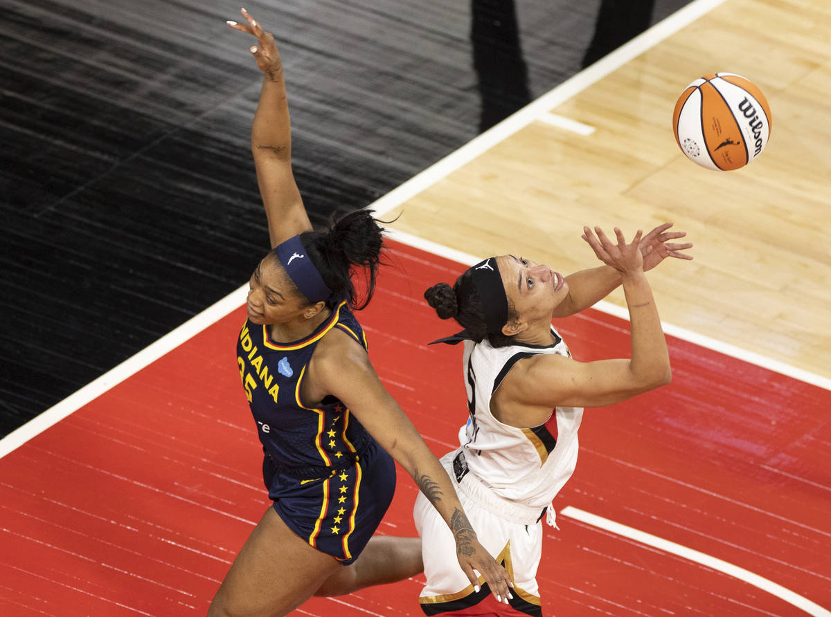Las Vegas Aces guard Chelsea Gray (12) attempts to block the shot of Indiana Fever guard Tiffan ...