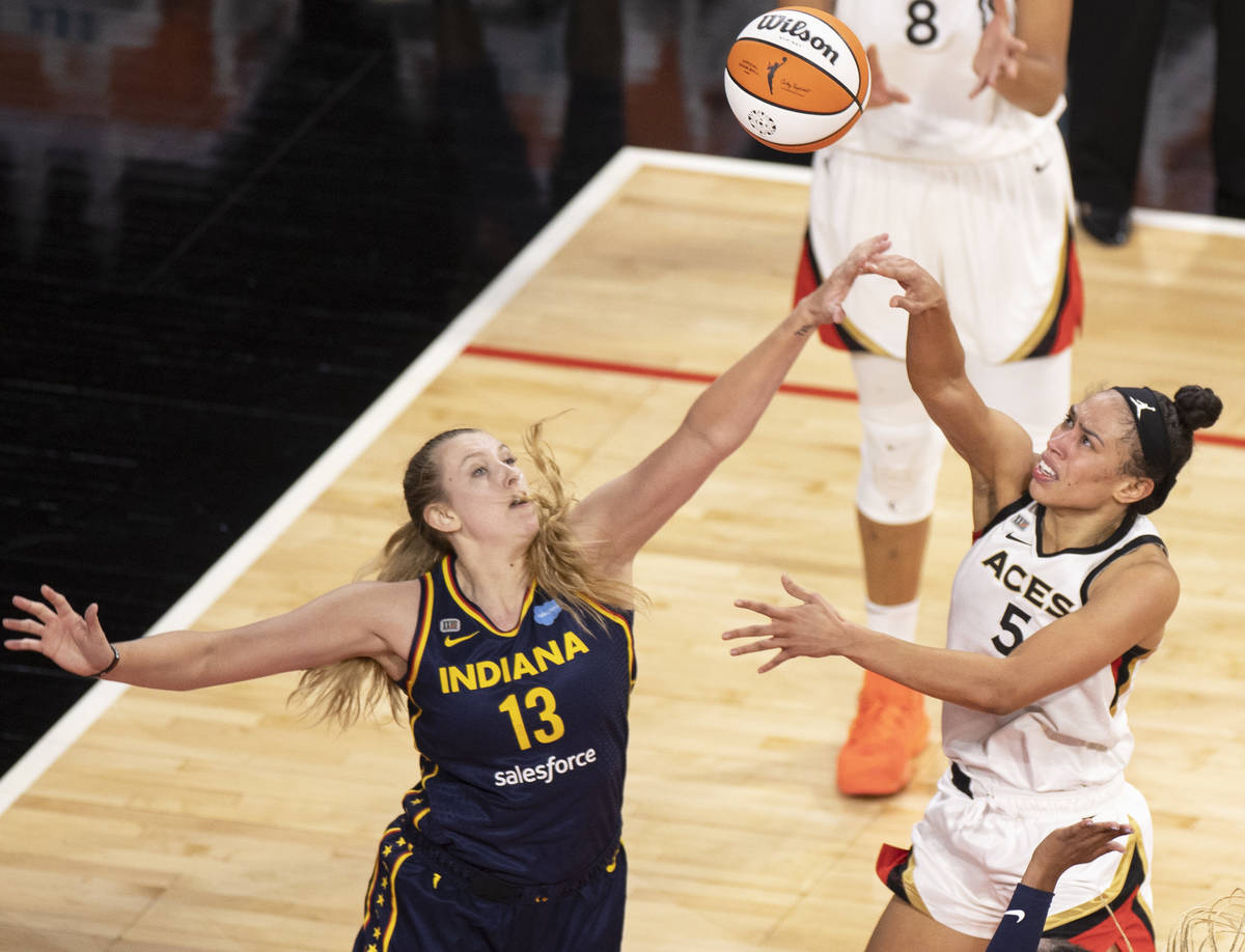 Las Vegas Aces forward Dearica Hamby (5) shoots over Indiana Fever forward Lauren Cox (13) in t ...