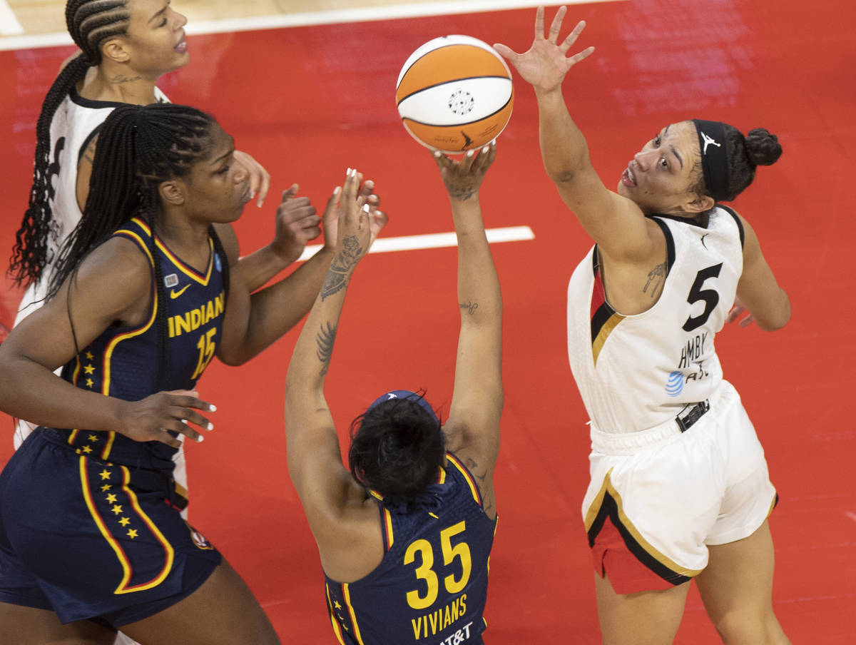 Las Vegas Aces forward Dearica Hamby (5) attempts to block the shot of Indiana Fever guard Vict ...