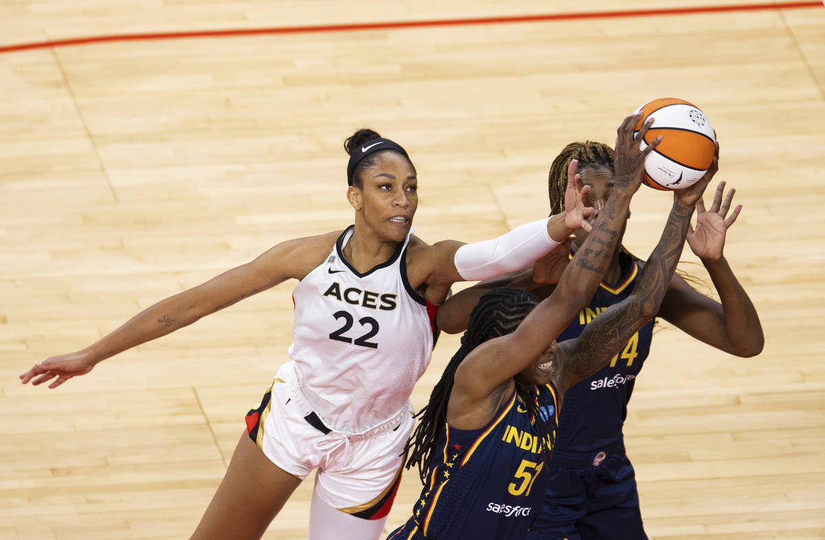 Las Vegas Aces forward A'ja Wilson (22) fights for a loose ball with Indiana Fever forward Jess ...