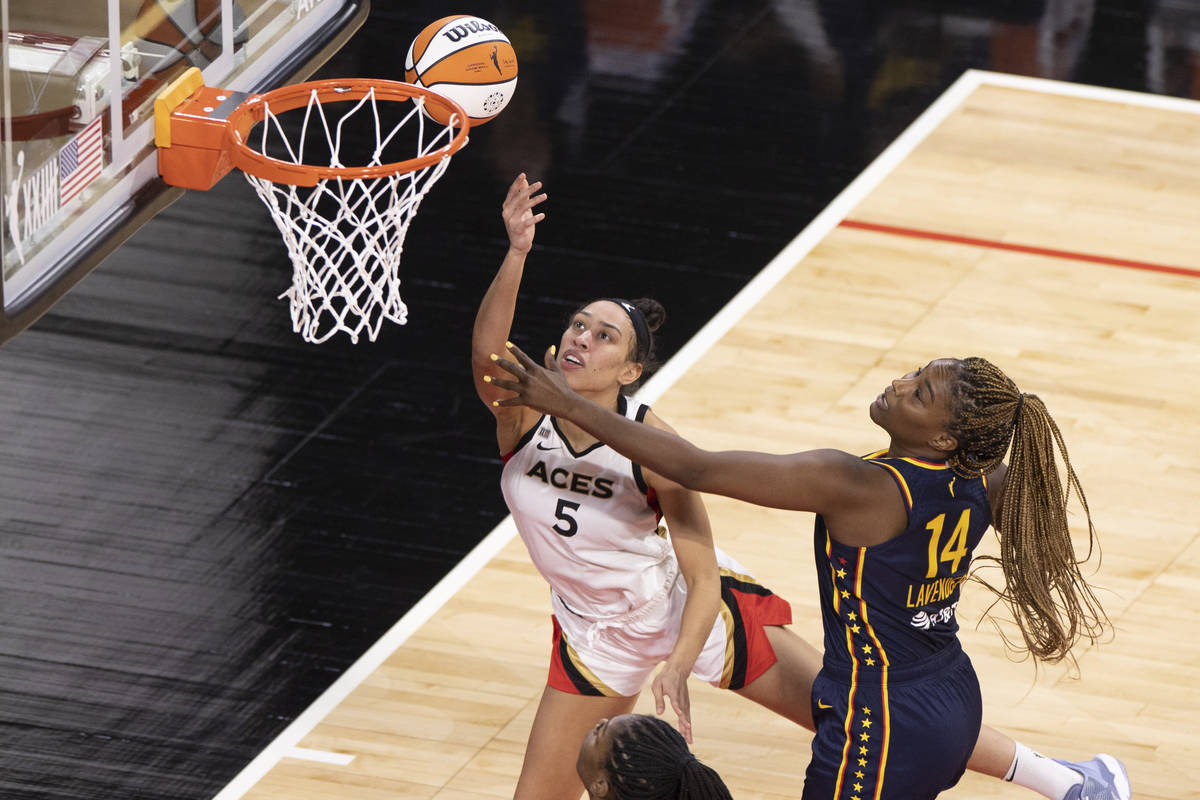 Las Vegas Aces forward Dearica Hamby (5) drives past Indiana Fever forward Jantel Lavender (14) ...