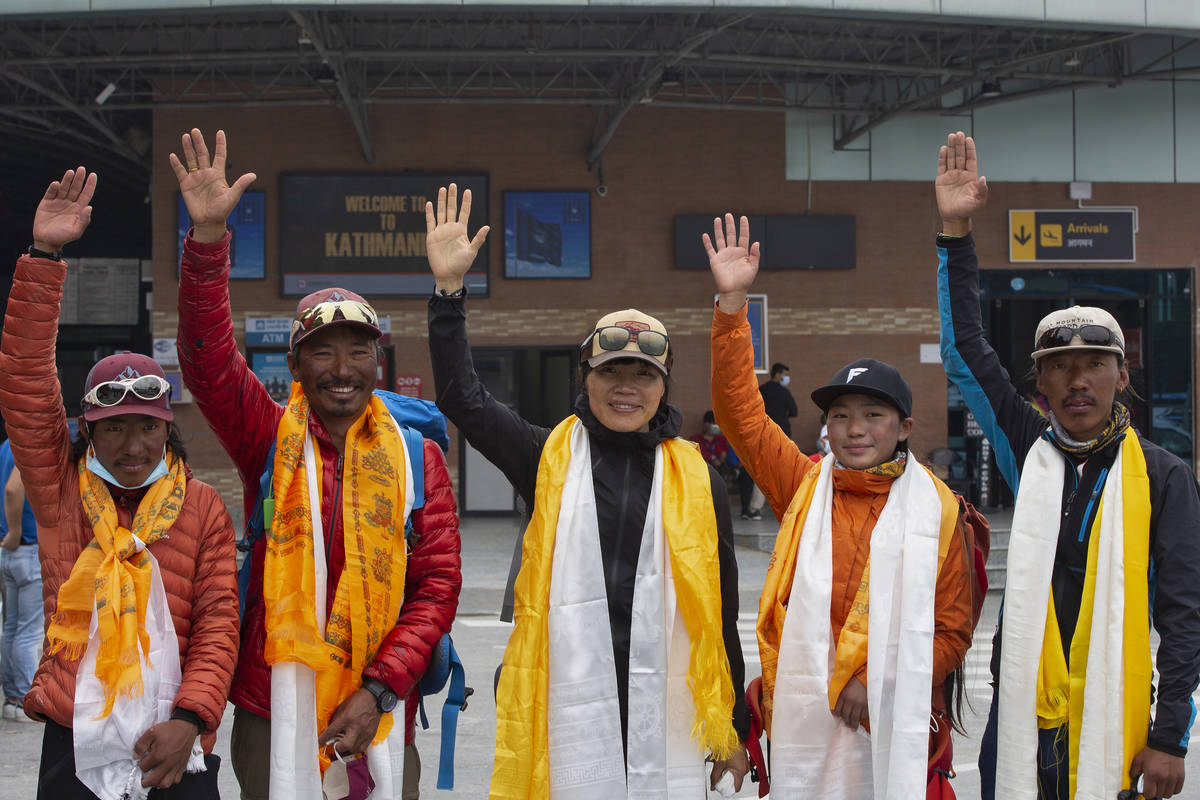 Tsang Yin-hung, 45, center, of Hong Kong who scaled Mount Everest from the base camp in 25 hour ...