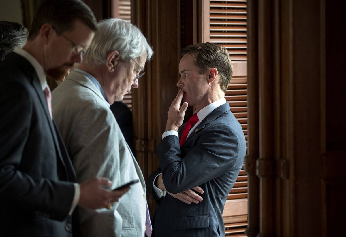 House Speaker Dade Phelan, R-Beaumont, right, talks to Republican members of the Texas House be ...