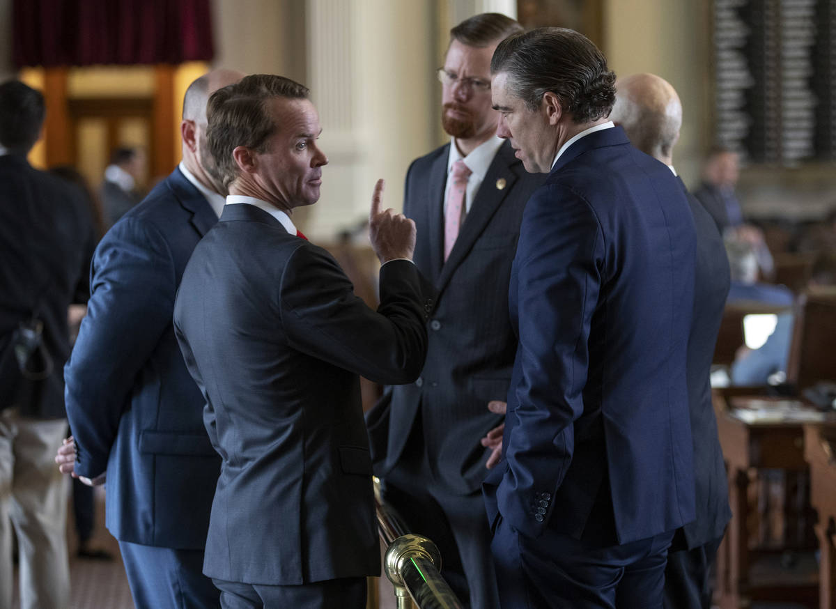 House Speaker Dade Phelan, R - Beaumont, left, talks to state representatives Will Metcalf, R - ...