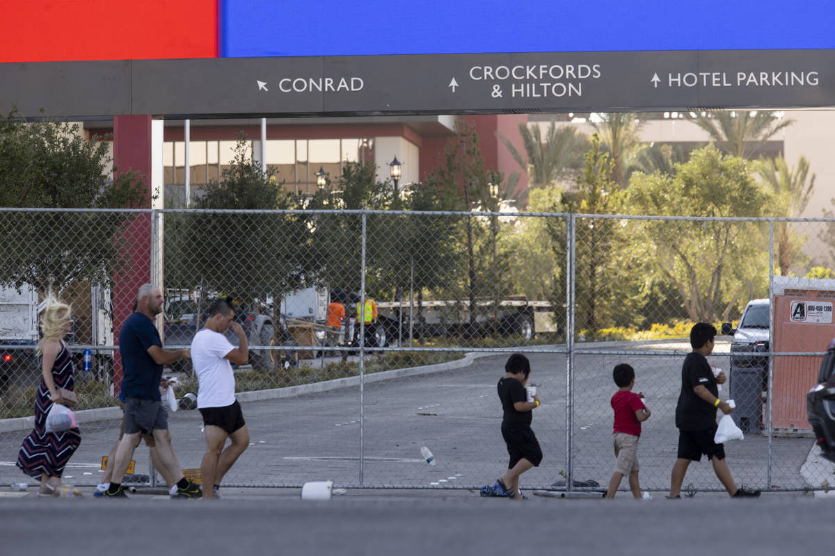 People walk across from the Resorts World Las Vegas under construction on Monday, June 21, 2021 ...