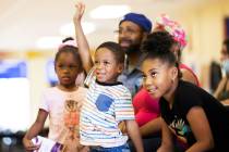 Ka’ron Smith, 4, middle, raises his hand to answer a question during a parent meeting at TEAC ...