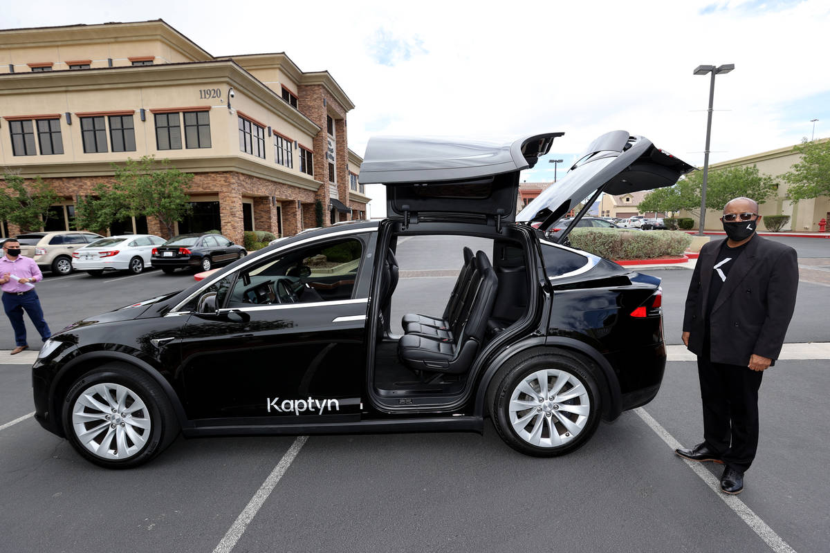 Kaptyn driver Menge Berhe shows one of a fleet of electric vehicles available for hire at compa ...