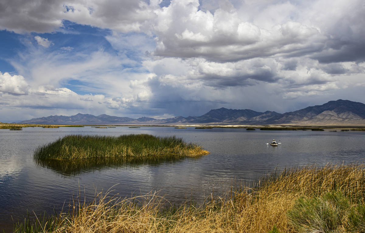 A fisherman uses a kayak in the Adams-McGill reservoir at the Wayne E. Kirch Wildlife Managemen ...