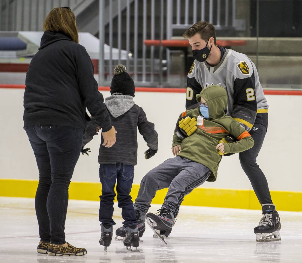 New Vegas Golden Knights goaltender Logan Thompson, right, helps a youngster with the Battle Bo ...
