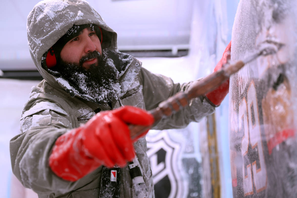 Ice artist Marco Villarreal works on a hockey themed wall at the Icebar at the LINQ Promenade i ...