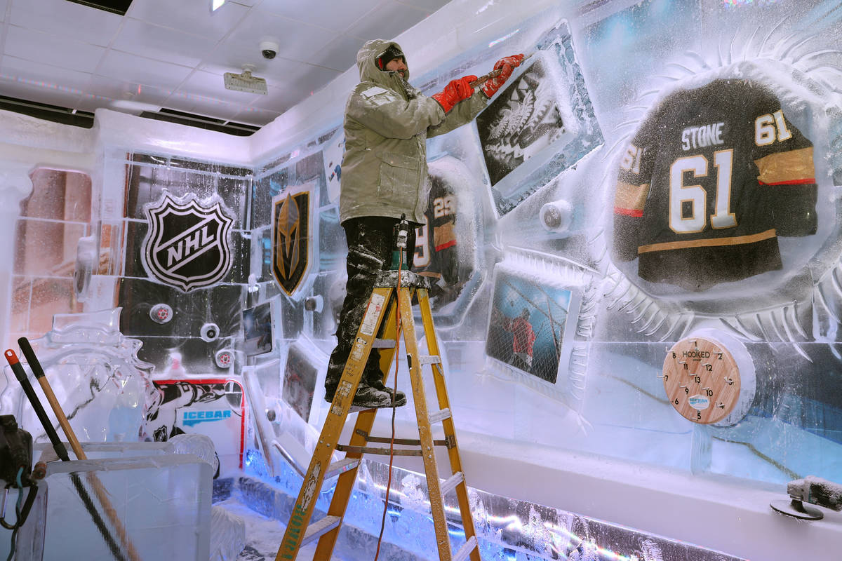 Ice artist Marco Villarreal works on a hockey themed wall at the Icebar at the LINQ Promenade i ...