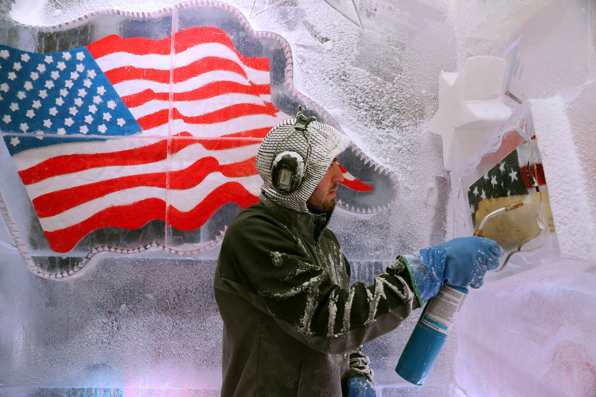 Ice artist Austin Greenleaf cleans an ice piece at the Icebar at the LINQ Promenade in Las Vega ...