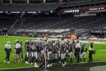 The Raiders huddle before an NFL football game against the Miami Dolphins with no fans in atten ...