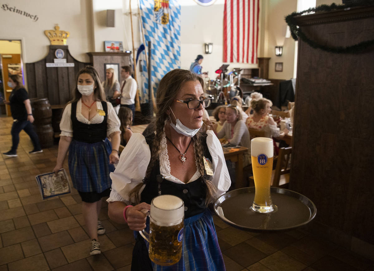 Servers deliver beer during the grand reopening of Hofbrauhaus Las Vegas on Tuesday, June 1, 20 ...