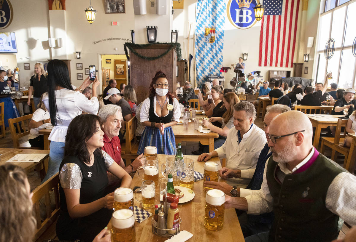 Guests are served beer by waitress Jennifer Alcantara, top/middle, during the grand reopening o ...