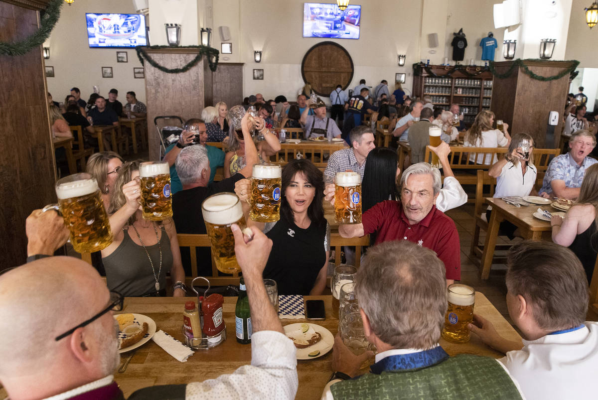 Guests raise their beer mugs for a cheers during the grand reopening of Hofbrauhaus Las Vegas o ...