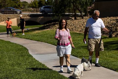 Alexandra Fujioka walks her dog, Dr. Watson, alongside a man who declined to give his name in S ...